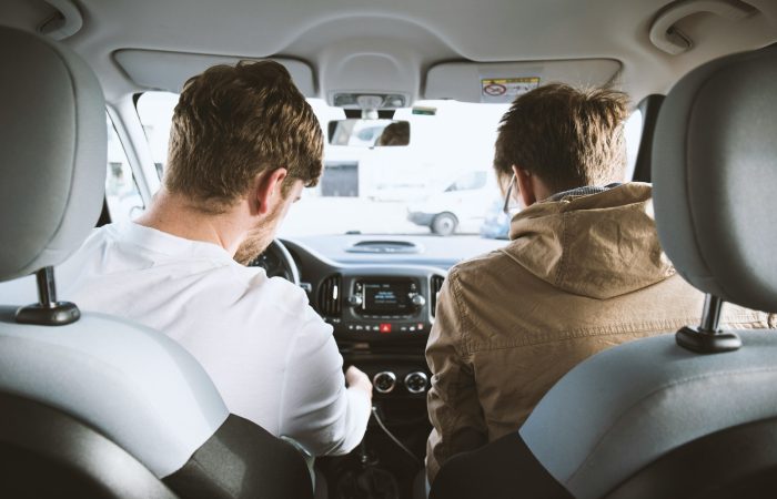 two men sitting inside vehicle